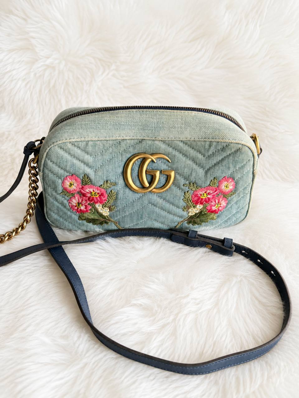 Gucci GG Marmont Denim Floral Embroidered Small Camera Bag featuring chevron-quilted blue denim and vibrant pink floral embroidery