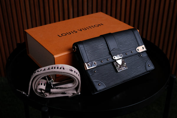 Authentic Louis Vuitton Epi Trunk Clutch in Black with LV strap.